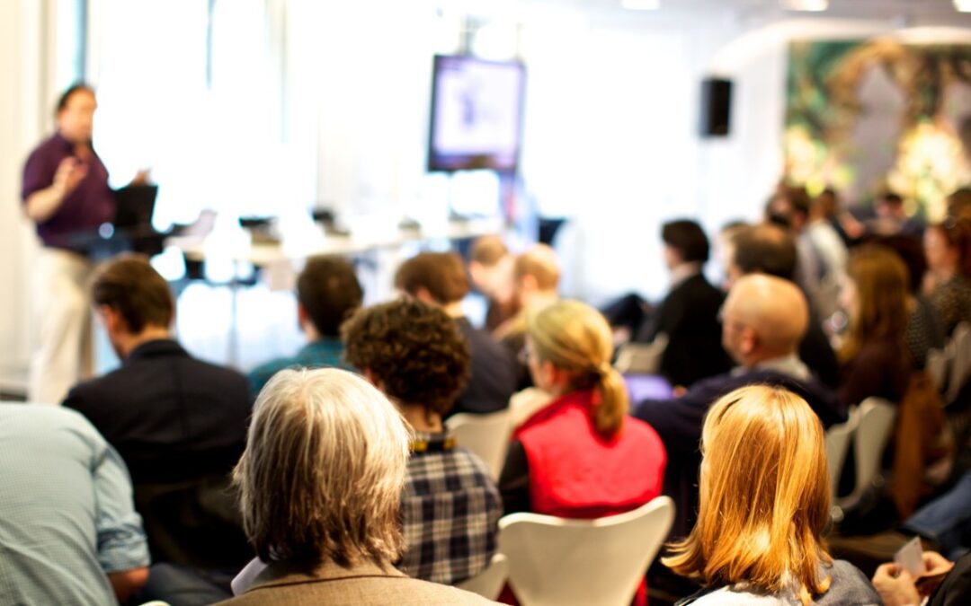 An organisation listening to a leader in an all-hands meeting
